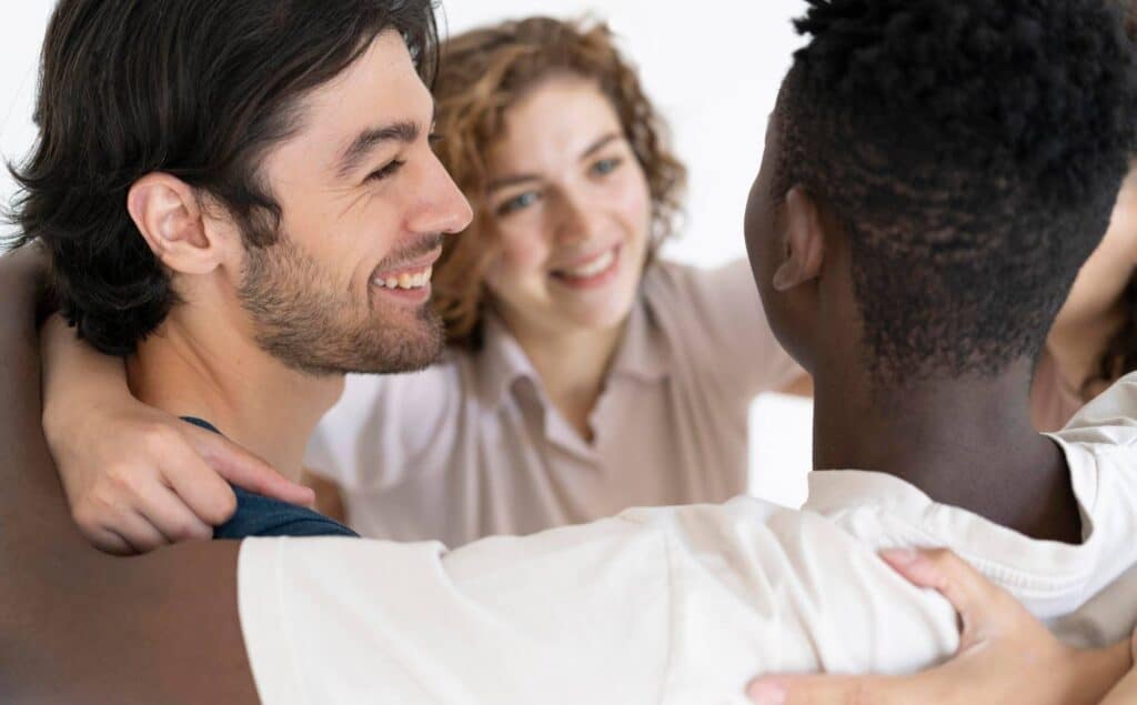 Clients sharing a supportive group hug at a rehab near Northfield, NJ.