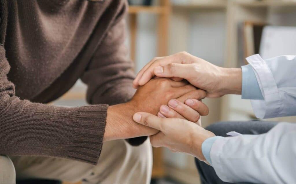 Professional offering support to a client at a young adults rehab in South Jersey.