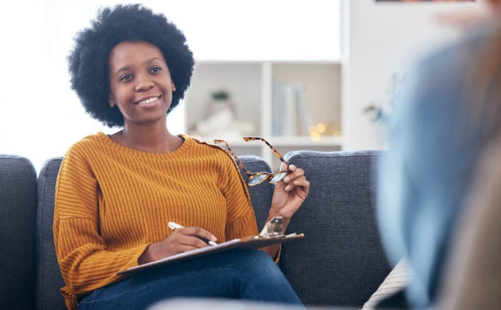 Therapist happily taking notes during a session at our rehab near Egg Harbor Township, NJ.