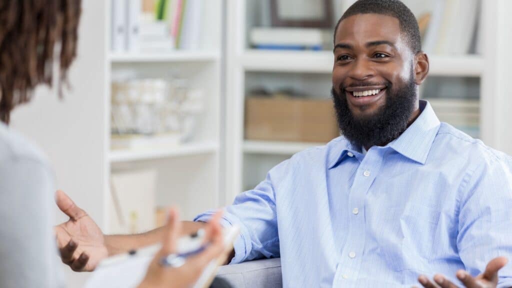 Happy man celebrating recovery after completing LSD addiction treatment in NJ